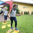 Crianças de máscara brincam dentro de um Centro de Educação Infantil