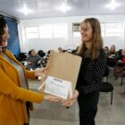 Mulher entrega sacola reutilizável para outra mulher