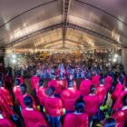 Coral, vestido de vermelho, se apresenta para público