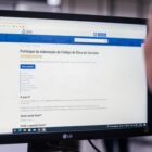 Mulher olha para tela de computador