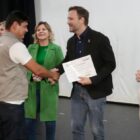 Agente de saúde recebe diploma das mãos do prefeito em palco