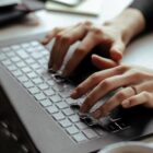 Pessoa digita em teclado de computador