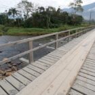 Ponte em madeira com rio por baixo