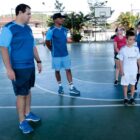 Crianças em quadra de esporte com professor