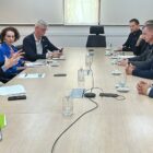 Autoridades reunidas sentadas em volta de uma mesa