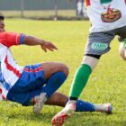 Dois jogadores de futebol de campo disputam bola em jogada