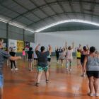 Pessoas praticando atividade esportiva em ginásio