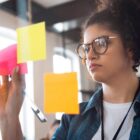 jovem cola papéis coloridos em vidro