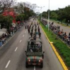 Homens com uniformes do exército marcham enfileirados durante o desfile de 7 de setembro em Joinville, com um jipe militar à frente