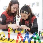 Professora e aluna montam kit de robótica